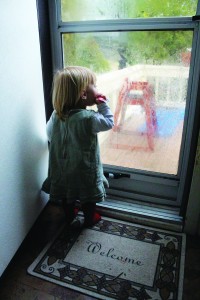Avah looks out at the front porch on a rainy Sunday