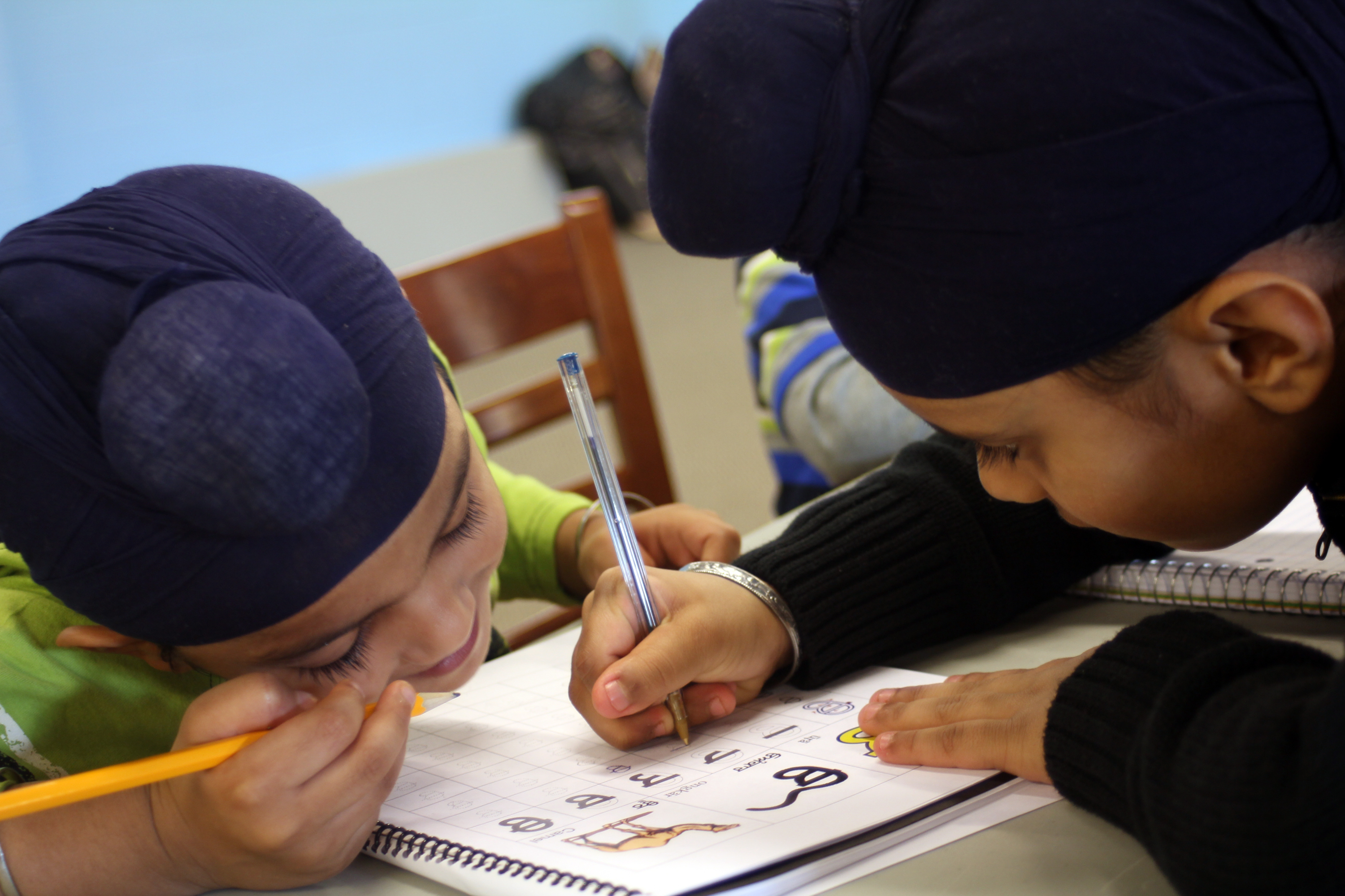 Downstairs in the basement, children work with their peers and teachers in Punjabi classes. The kids learn to read, write and speak the language.
Photo by: Aimee Katz